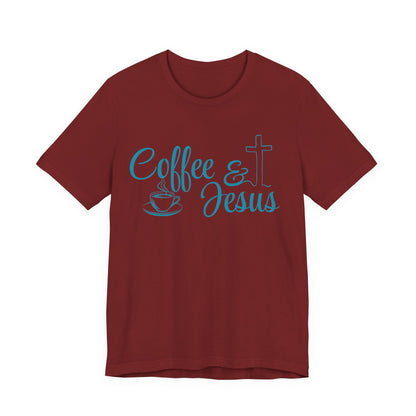A short-sleeve crewneck t-shirt in maroon red, featuring a light blue graphic on the chest that reads 'Coffee & Jesus' alongside a coffee cup icon and a Christian cross.