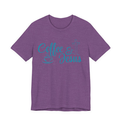 A heather purple short-sleeve t-shirt with a turquoise graphic on the front reading 'Coffee & Jesus' alongside a coffee cup and a cross.