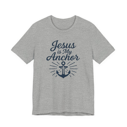 A heather gray short-sleeve t-shirt with a navy blue graphic print on the front that reads 'Jesus is My Anchor' above an anchor illustration with radiating lines.