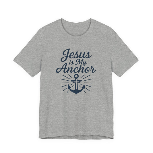 A heather gray short-sleeve t-shirt with a navy blue graphic print on the front that reads 'Jesus is My Anchor' above an anchor illustration with radiating lines.