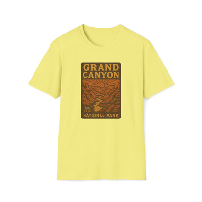 A pale yellow short-sleeve crewneck t-shirt featuring a rectangular 'Grand Canyon National Park' graphic on the chest, displayed against a solid white background.