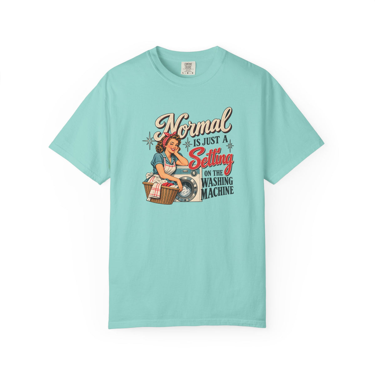 A light aqua blue short-sleeve t-shirt with a vintage-style graphic on the front. The graphic features a pin-up illustration of a woman washing a shirt next to a laundry basket, with the text 'Normal is just a Setting on the Washing Machine' in stylized fonts.