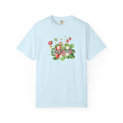A light blue short-sleeve crewneck t-shirt featuring a colorful watercolor graphic of strawberries, green leaves, and the words 'Stay Sweet' in cursive across the chest.