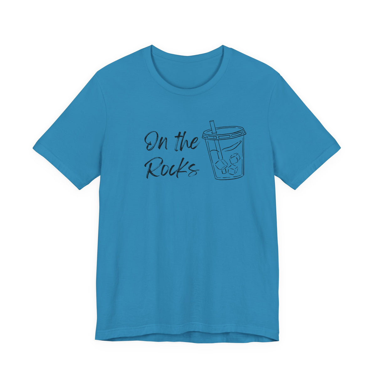 A bright blue short-sleeve crewneck t-shirt with a dark graphic on the chest that reads 'On the Rocks' next to a simple outline drawing of a iced coffee cup.