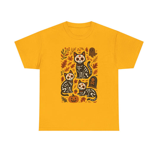 A yellow short-sleeve crewneck t-shirt featuring a central graphic of four black and white sugar-skull cats surrounded by autumn leaves, pumpkins, and a tombstone.
