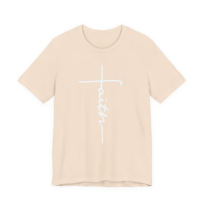 A light beige crewneck t-shirt featuring a white graphic on the front that combines a Christian cross with the word 'faith' written in cursive script.