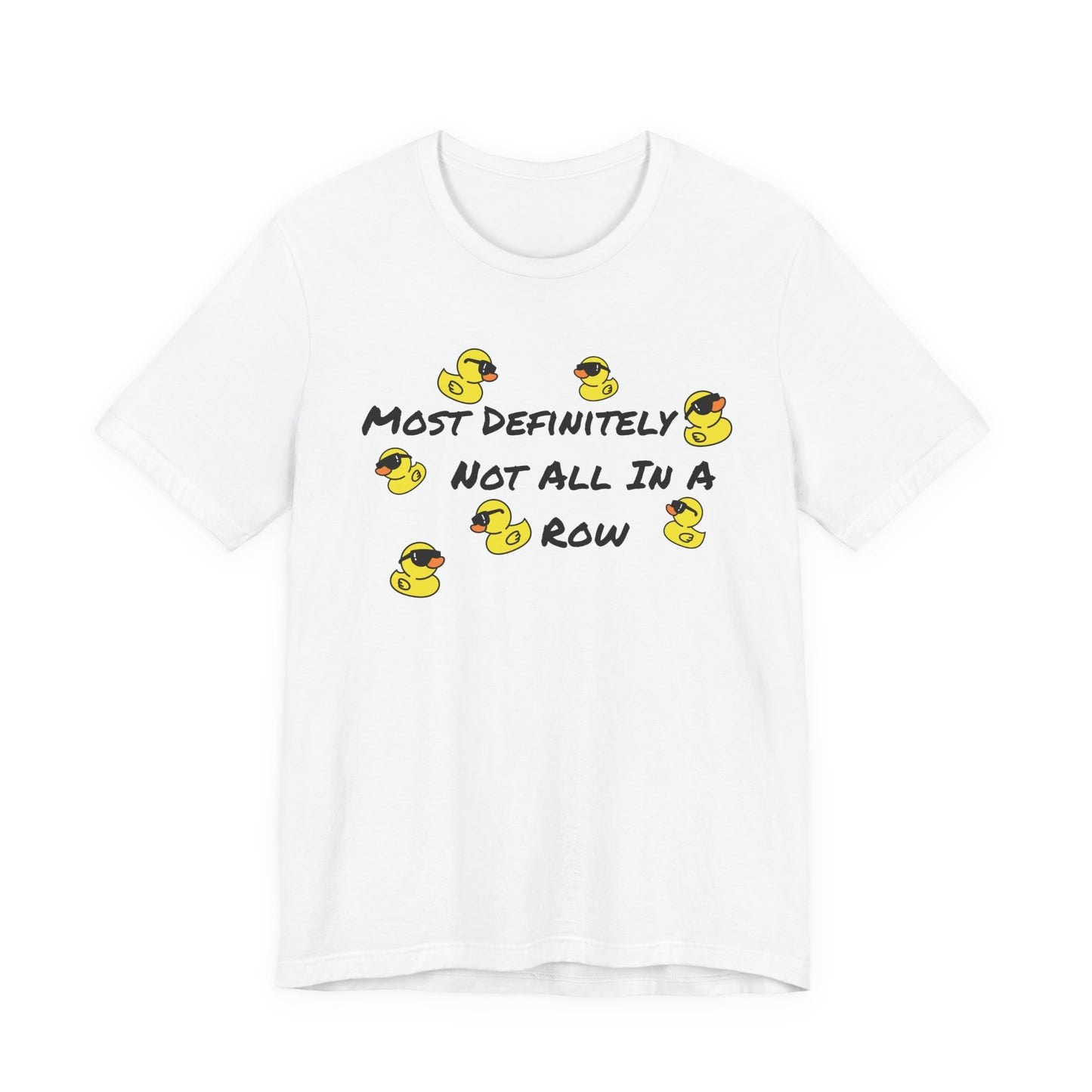 A white short-sleeve crewneck t-shirt featuring a graphic print of yellow rubber ducks and the text 'MOST DEFINITELY NOT ALL IN A ROW' in black.