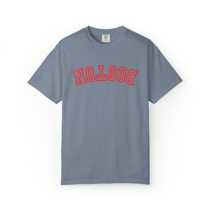 A slate blue short-sleeve t-shirt with 'BOSTON' printed in red arched varsity letters across the chest, displayed flat against a white background.