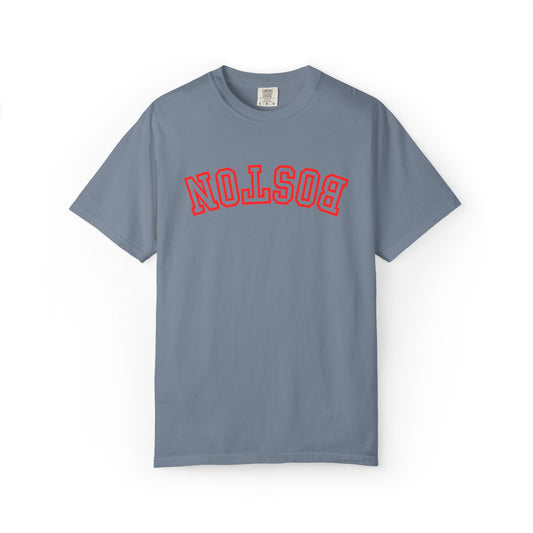 A slate blue short-sleeve t-shirt with 'BOSTON' printed in red arched varsity letters across the chest, displayed flat against a white background.