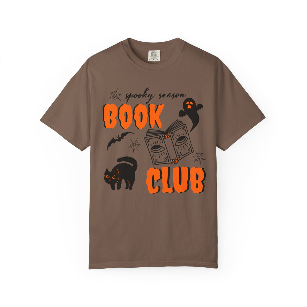 A brown short-sleeve crewneck t-shirt featuring a 'spooky season BOOK CLUB' graphic on the front with orange text, a black cat, a ghost, and a book illustration, displayed on a clean white background.