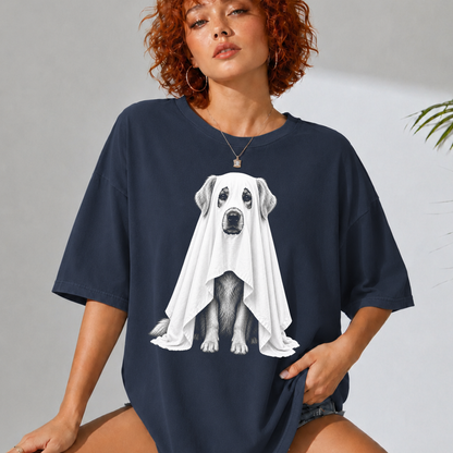 A woman wearing an oversized navy blue t-shirt with a graphic of a dog covered in a white ghost, posed against a light gray wall.